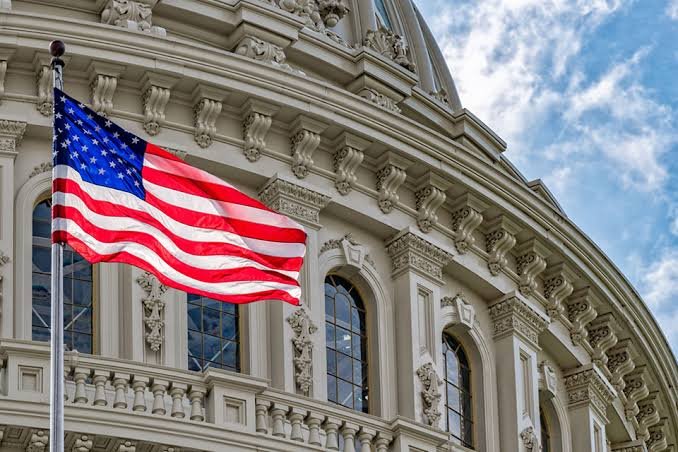 American flag in front of an ornate stone building